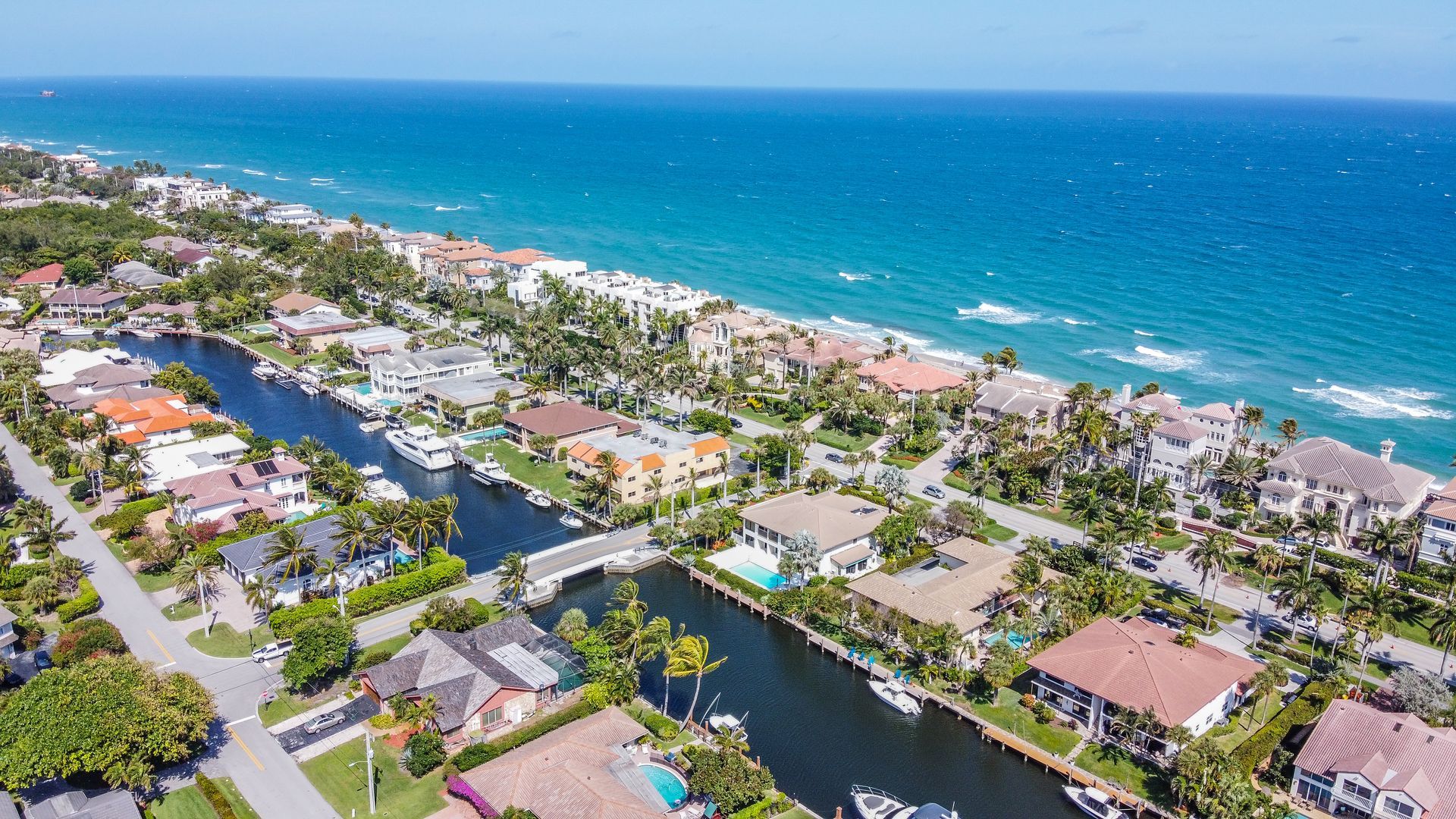 An aerial view of a residential area next to the ocean.